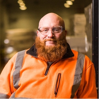 Man with safety glasses smiling