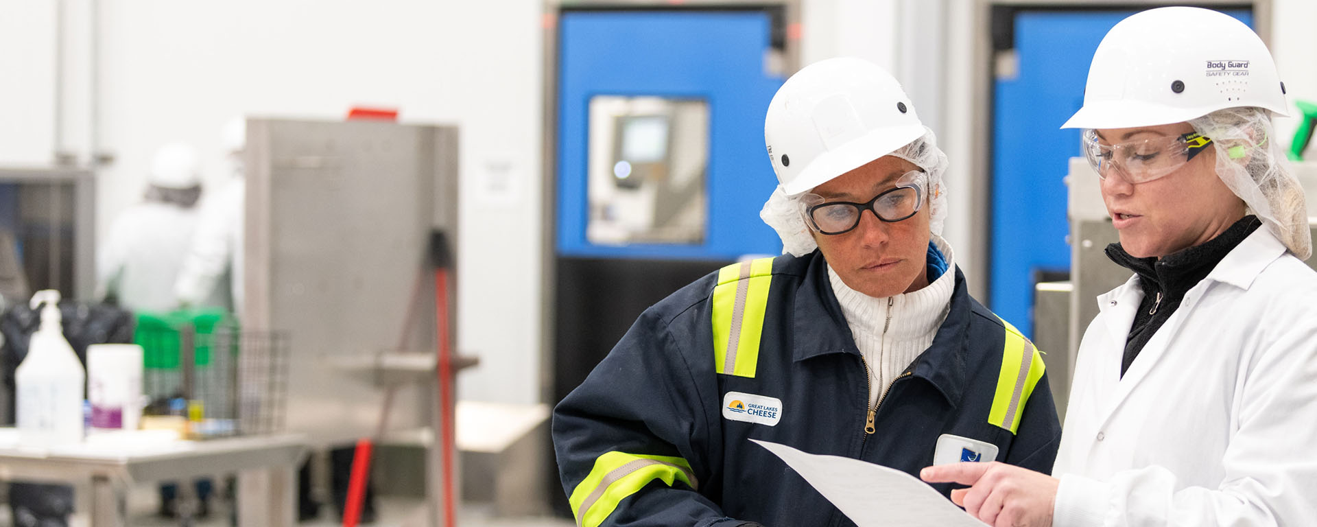 Two employees reviewing a form