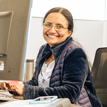 Happy smiling employee at her computer