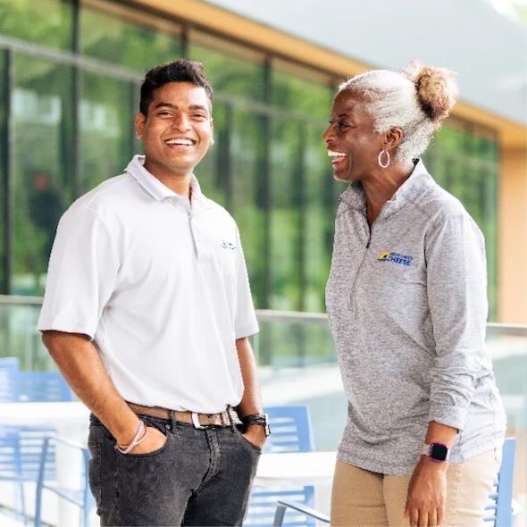 Two coworkers laughing together