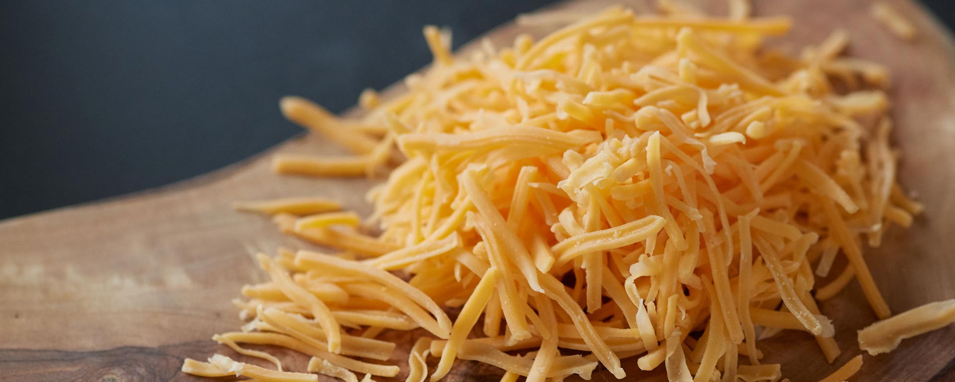 Shredded cheese on a block of wood