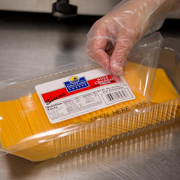 Large container of sliced cheddar cheese